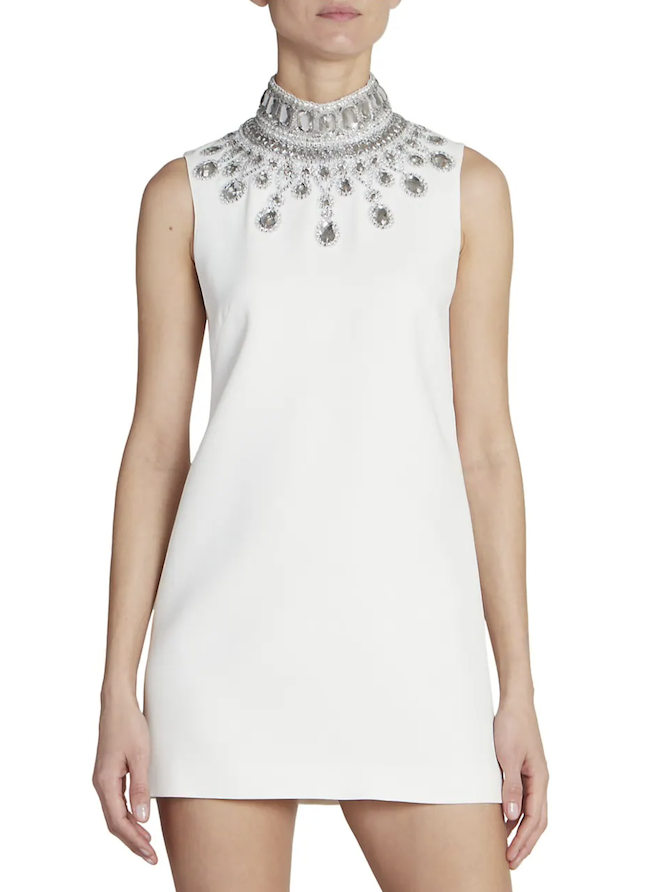 A white mini dress with a jeweled collar.