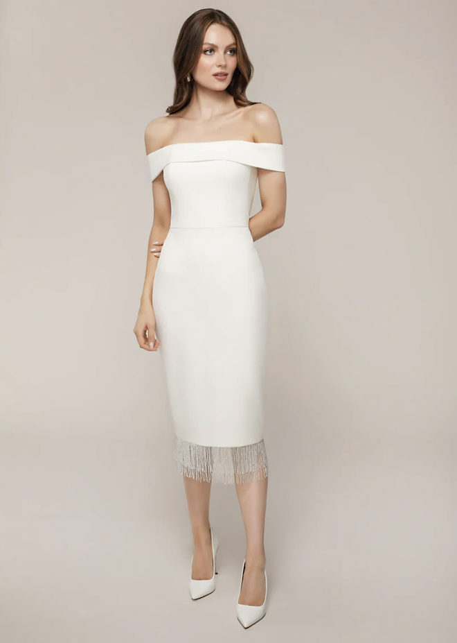 A white knee length dress with beaded fringe.