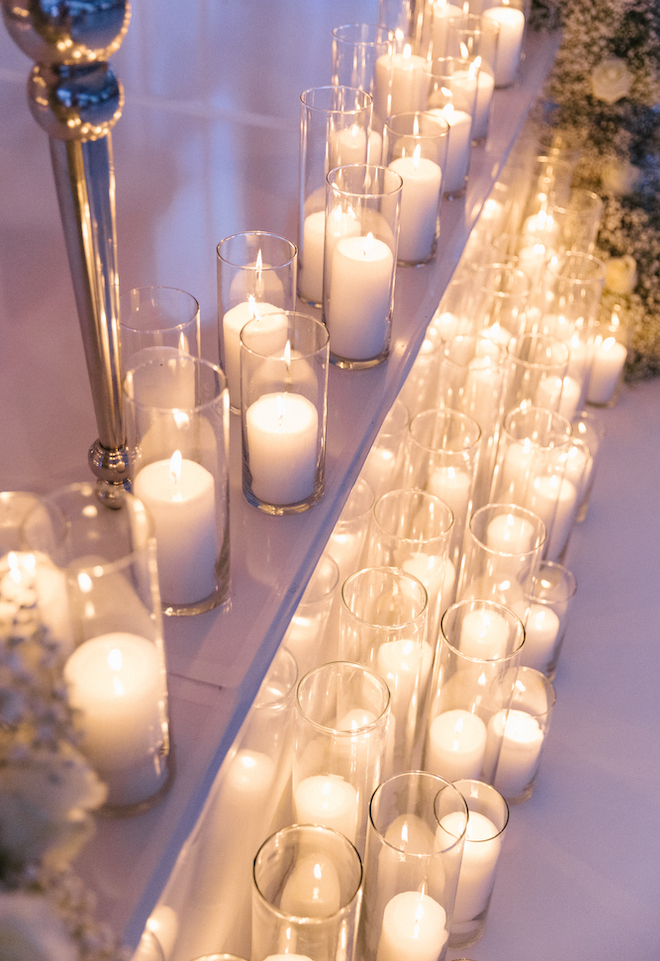 Candlelight as decorations for the all-white wedding.