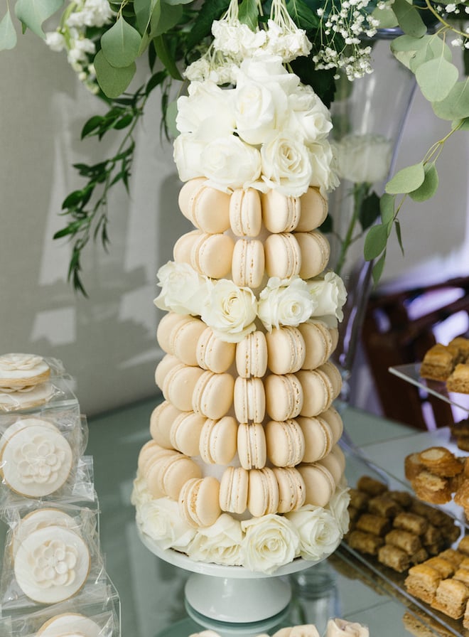 White macaroon tower decorated with roses at a wedding at Omni Houston Hotel. 