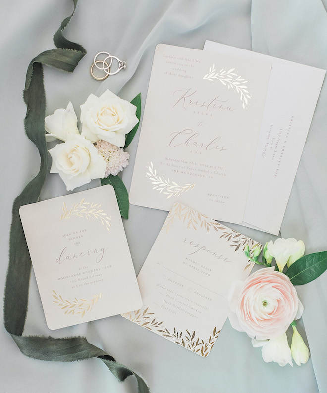 A white sage and blush wedding invitation suite with gold accents.