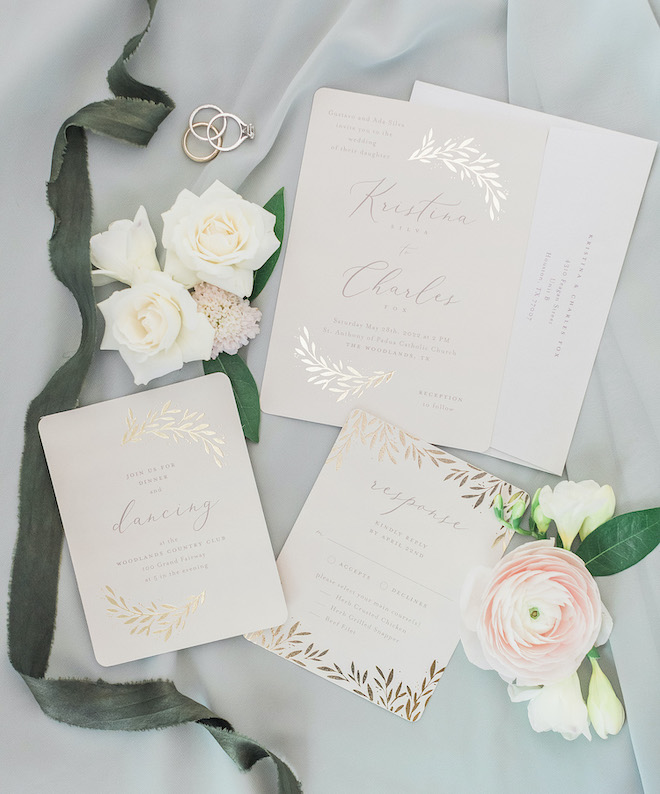 A white sage and blush wedding invitation suite with gold accents.