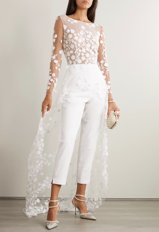 A white lace jumpsuit with a train.