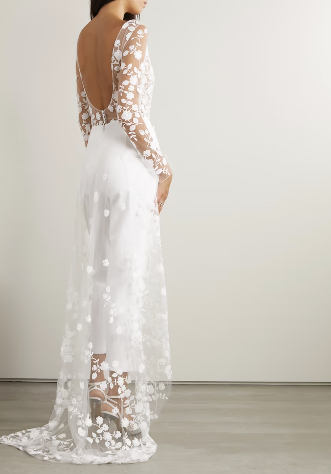 The back of a white lace jumpsuit with a train.
