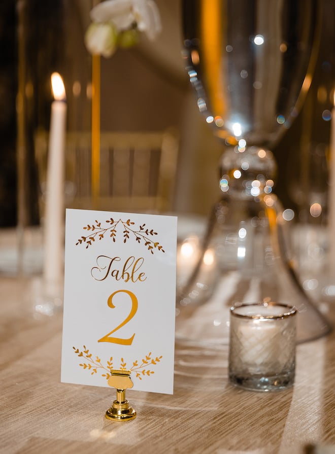 A white card reading "Table 2" in gold.
