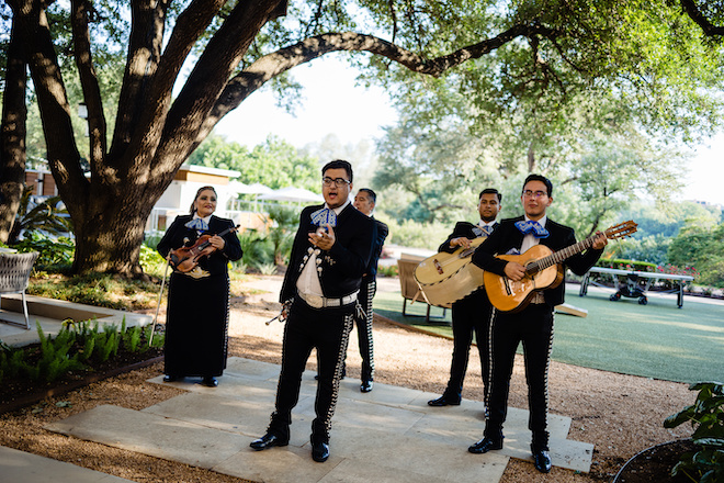 The mariachi band performing outside.