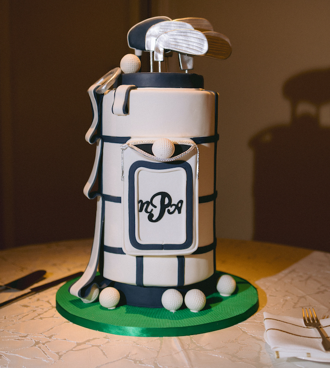 A groom's cake made to look like a golf bag with the groom's initials on it with golf clubs and golf balls in the cake. 
