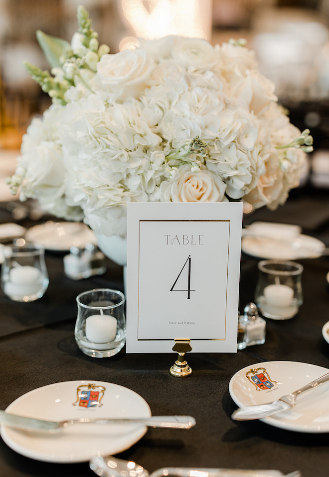 A "Table 4" sign with a white floral arrangement.