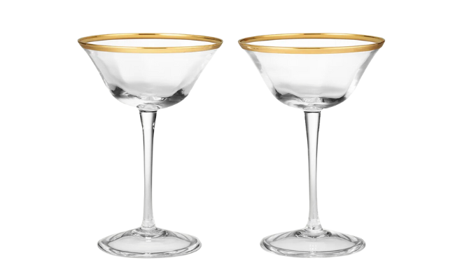 Two hand-blown crystal coupe glasses with gold rim from Aerin.