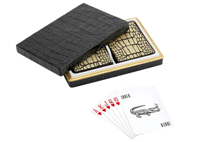 A black crocodile box with gold and black crocodile print playing cards.