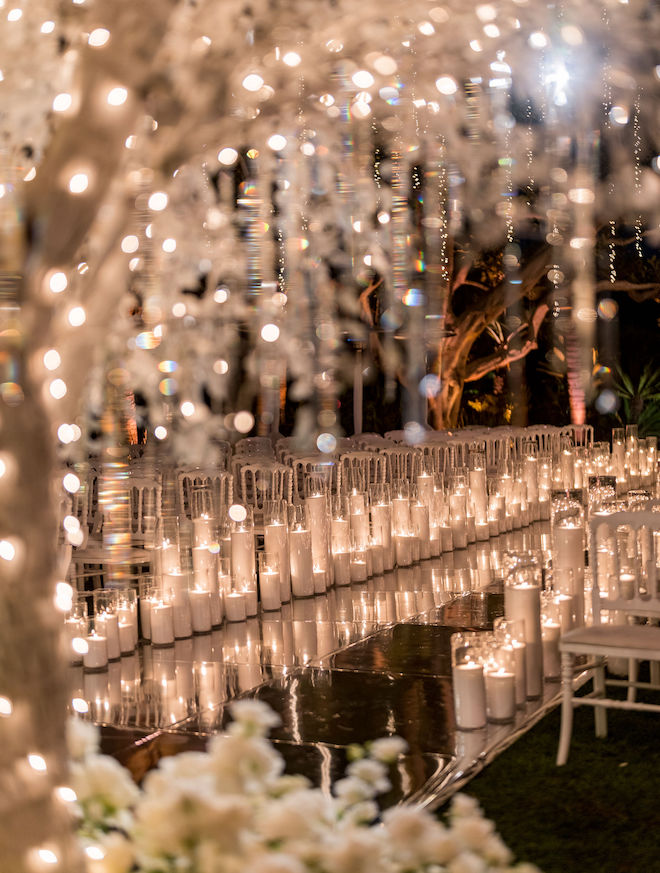 The mirrored aisle lined with candles.