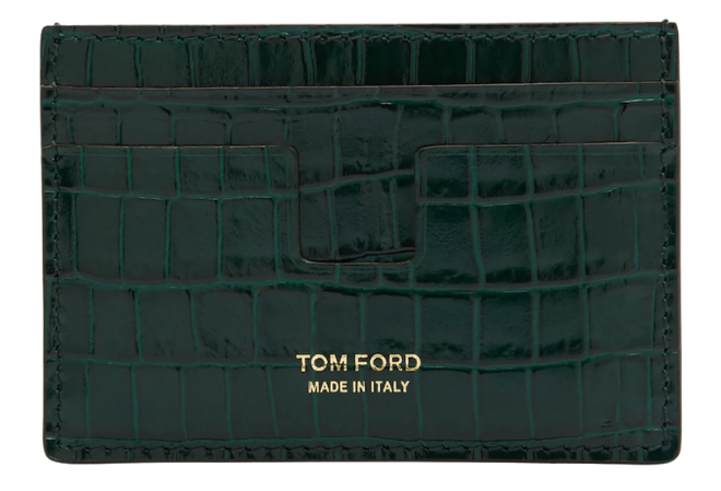 A glossy green crocodile wallet with gold words reading "Tom Ford Made in Italy."