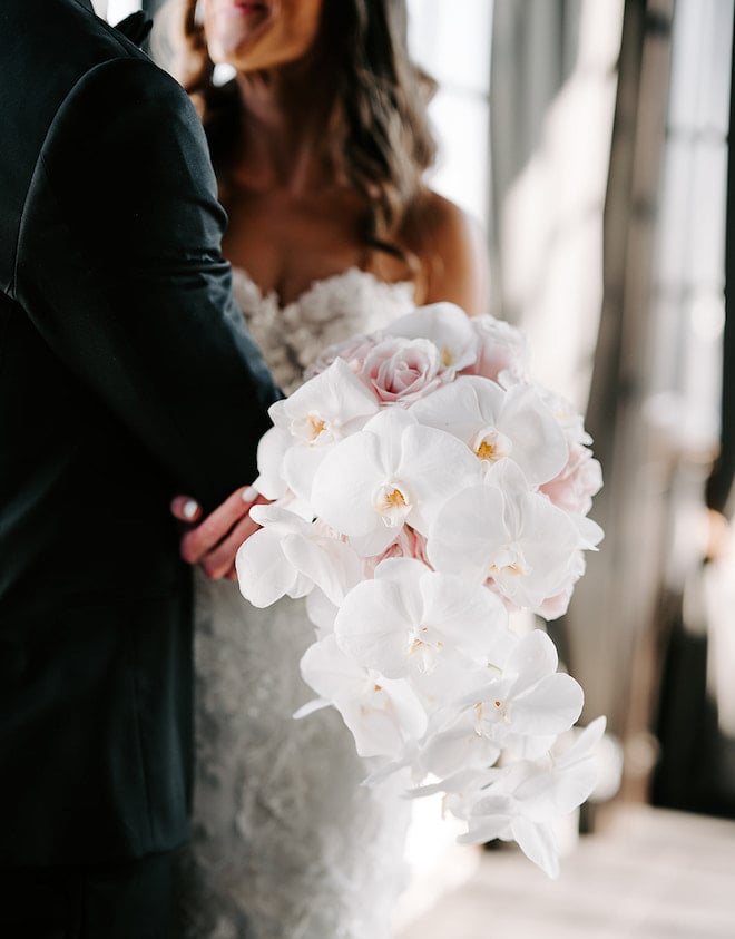 The brides bouquet with white orchids and light pink roses. 