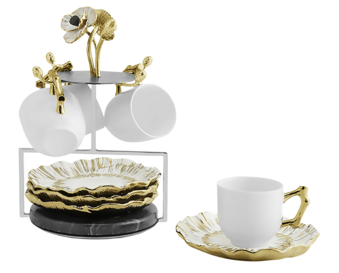 A white and gold demitasse set with white cups with gold hands and white and gold plates featured in Weddings in Houston Magazine for wedding registry essentials.