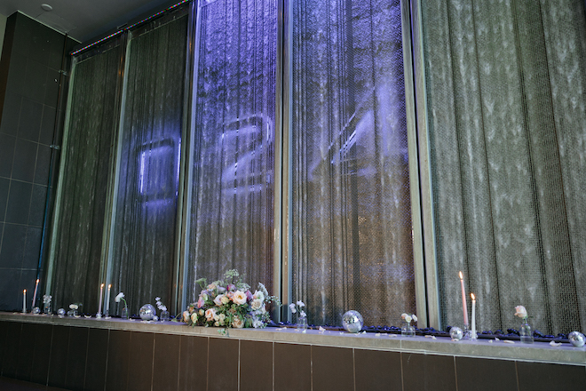 The Westin Houston Memorial City's restaurant, 024 Grille waterfall with disco balls, candles and floral arrangements. 
