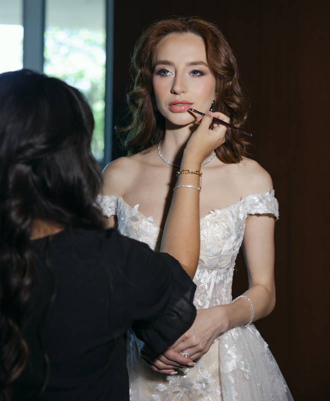 Lilly Bridal Artistry putting lip liner on the bride. 