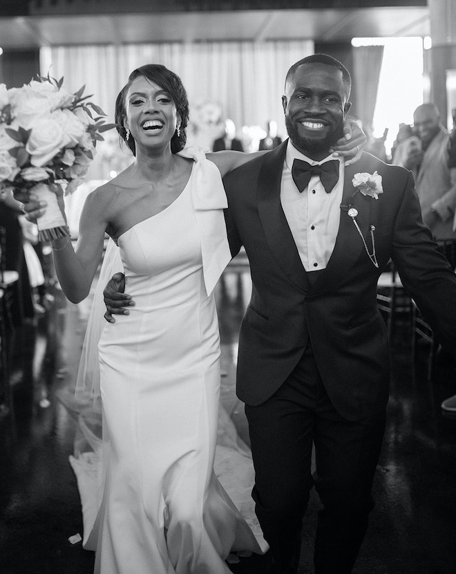 The bride and groom smiling walking down the aisle.