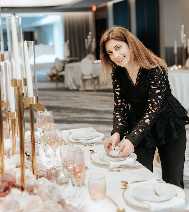 Marcela Bogado, owner of Malleret Designs, setting up a tablescape.