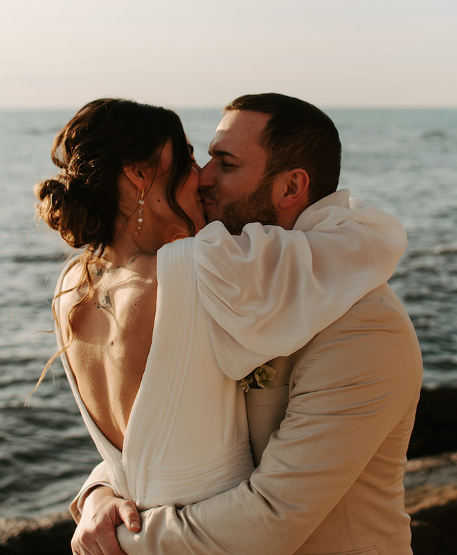 The bride and groom kissing during their sunset elopement. 