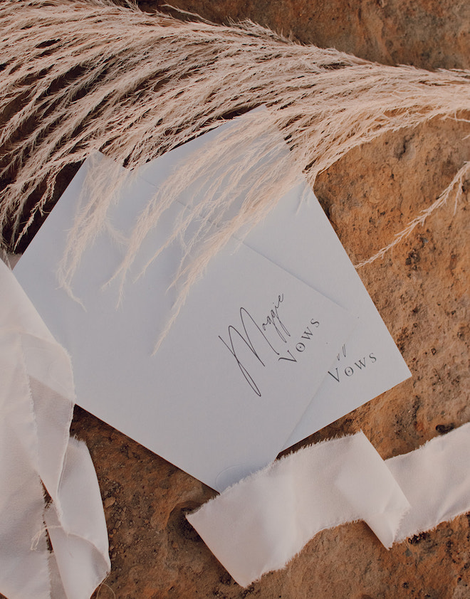 White booklets with "Maggie's vows" written in cursive. 