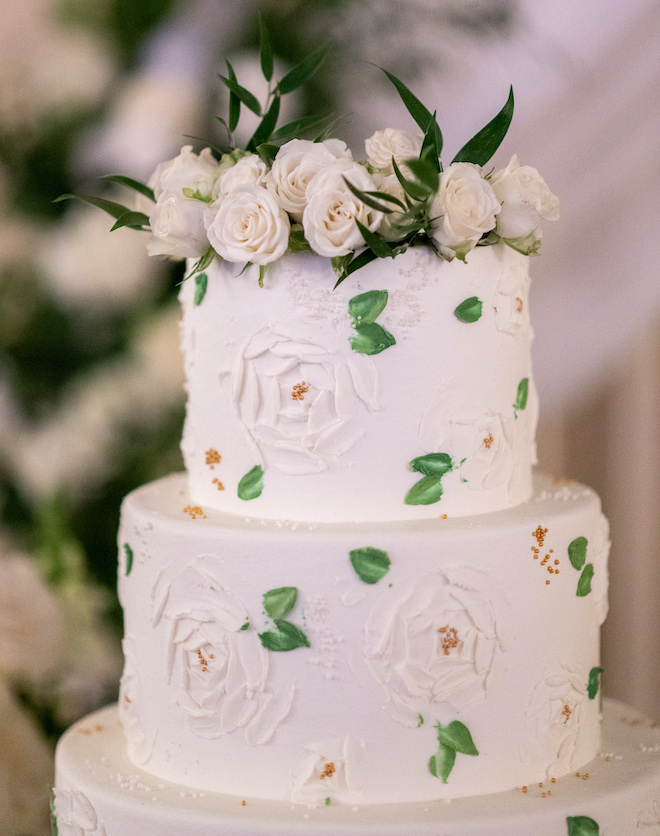 The top two tier of the cake with floral detailing by Susie's Cakes.