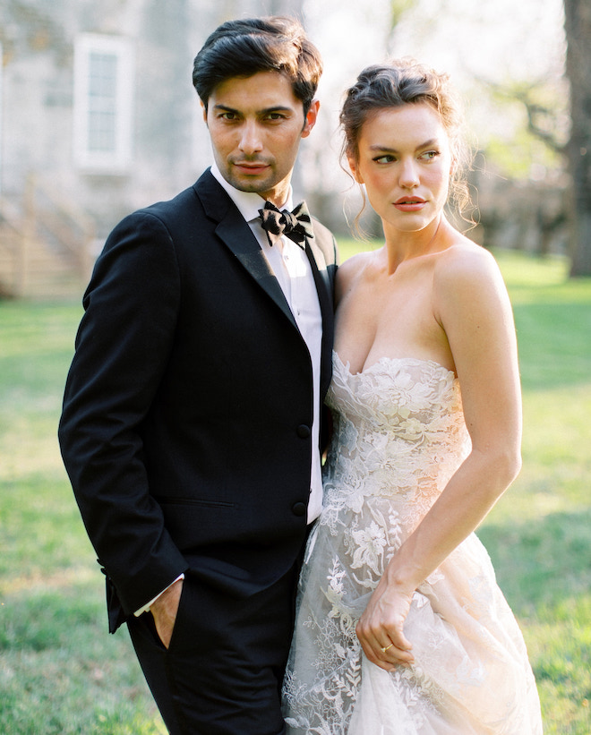 A bride and groom posing outside the historic Salubria Manor. 