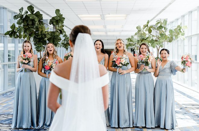 Before walking down the aisle, the bride reveals her first look with her bridesmaids. 