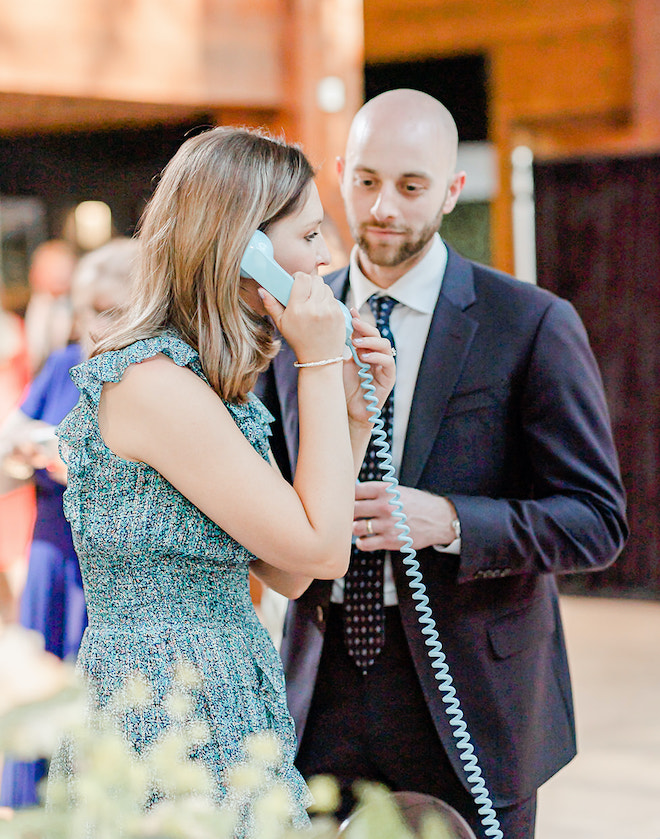 Wedding guests at the reception leave messages on the audio guestbook for the bride and groom.