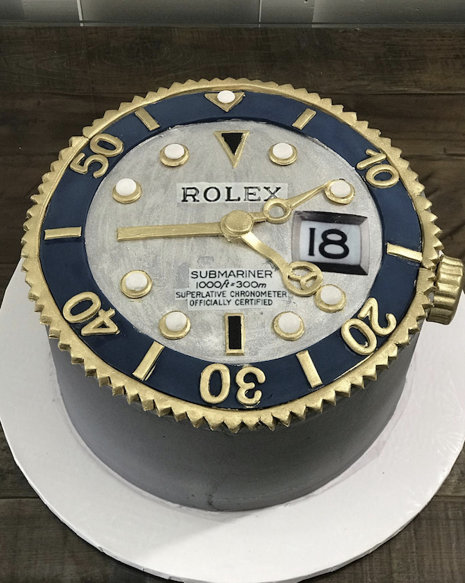 A Rolex-styled watch with blue and gold accents is designed by For Heaven's Cake for the groom.