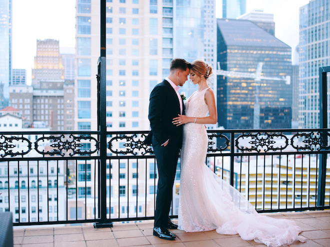 A bride and groom on the Hotel Icon terrace overlooking downtown Houston.