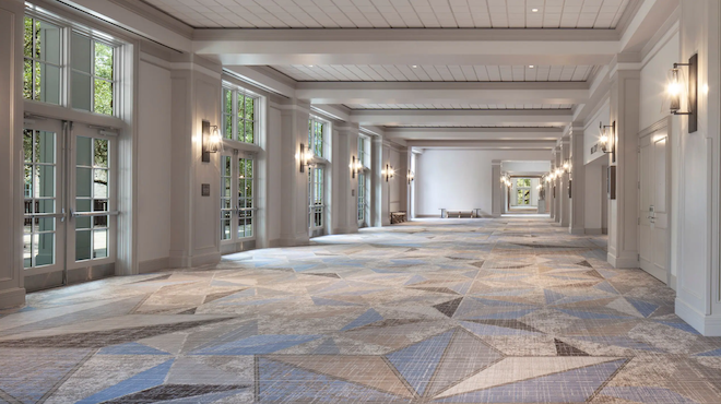 Newly renovated ballroom with modern chandeliers and blue and gray carpeted flooring at Hyatt Regency Hill Country Resort and Spa