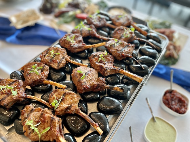 The lamb lollipops, a guest favorite, are served on a silver platter for wedding guests. 