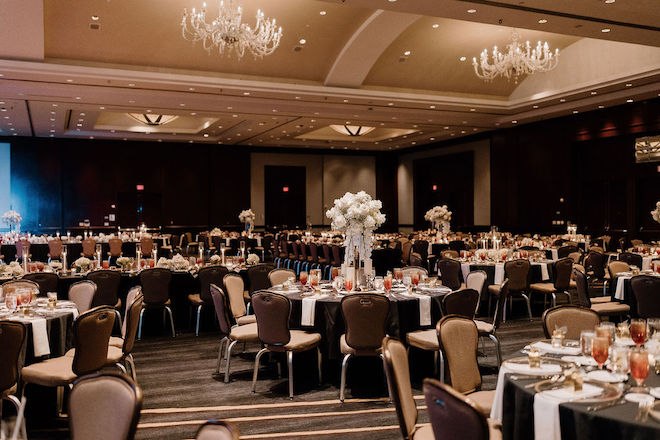 A ballroom reception at The Royal Sonesta Houston Galleria decorated with black, white and beige accents. 