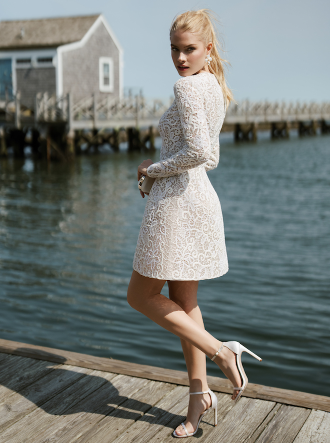 A lace long sleeve mini dress by Anne Barge. 
