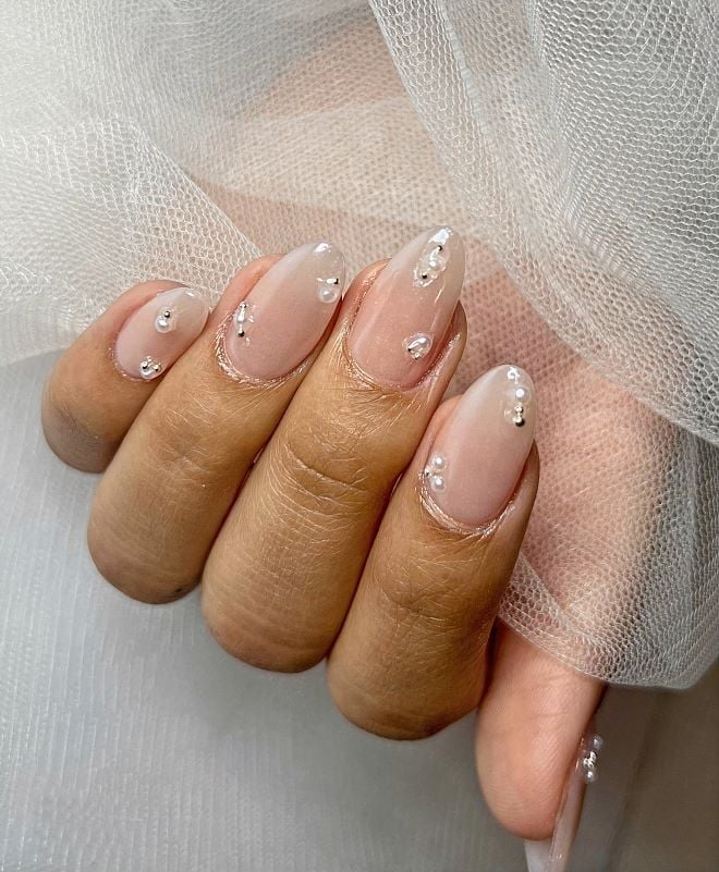 A blush pink wedding manicure with rhinestone accents from Milano Nail Spa The Heights.