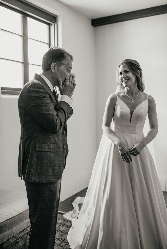 The bride and her father have a tearful first look before walking down the aisle. 