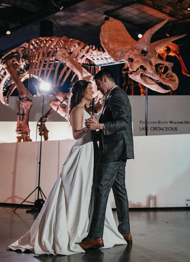 The bride and groom dance at their charming wedding at the Houston Museum of Natural Science. 