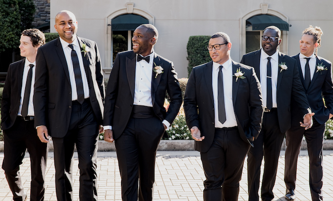 The groom and his groomsmen pose outside outside the wedding venue, The Royal Oaks Country Club.