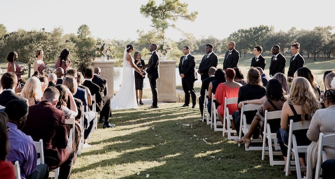 The bride and groom exchange vows at their outdoor wedding ceremony at the Royal Oaks Country Club.