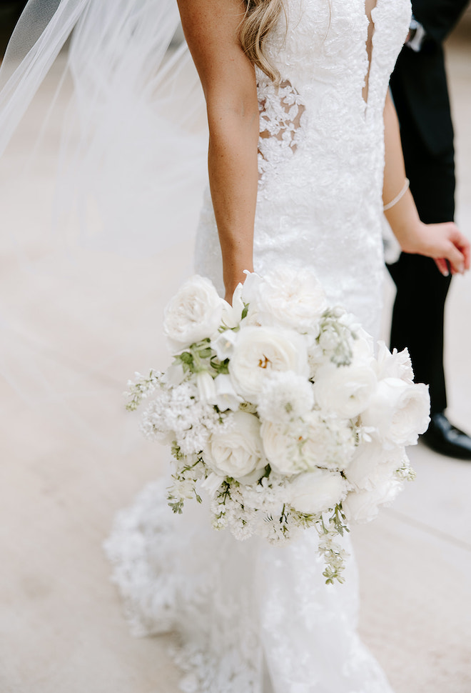 The brides all-white bouquet with hints of greenery. 