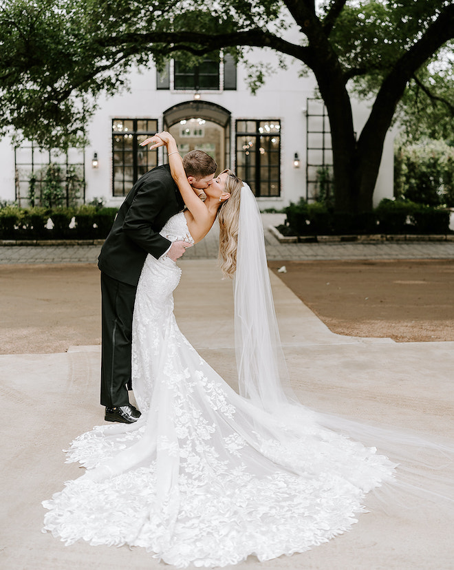 Bride and groom kissing in front of the chapel. 