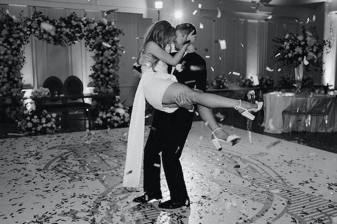 The bride and groom having a final dance on the dance floor with confetti in the air. 
