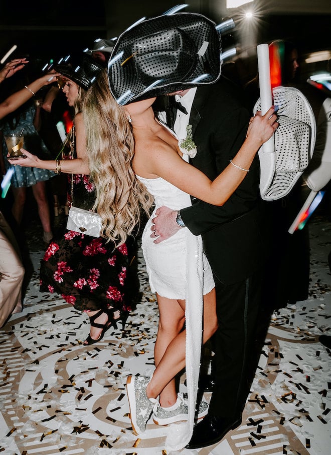 The bride and groom kissing on the dance floor. 