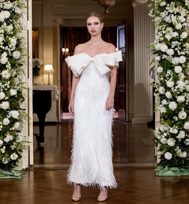 A feather gown with a bow on the chest by Nardos. 