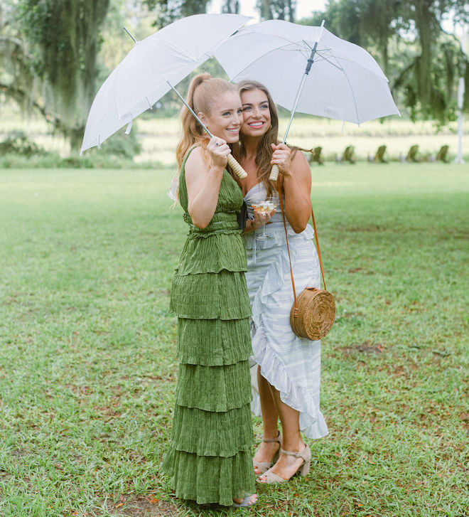 Two girls wearing green and blue dresses for a garden party wedding. 
