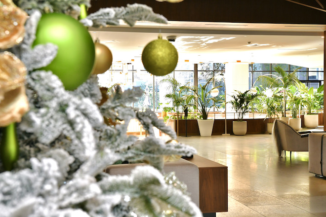 Christmas tree with green ornaments in the lobby of downtown Houston hotel venue, C. Baldwin Hotel.