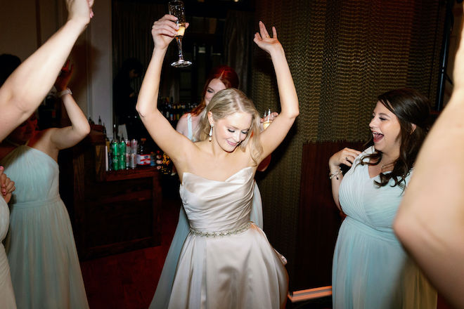 The bride dancing with her bridesmaids. 