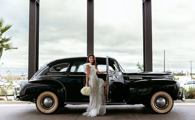 The model steps into a vintage Chrysler as her getaway car from the Hyatt Regency Baytown - Houston. 