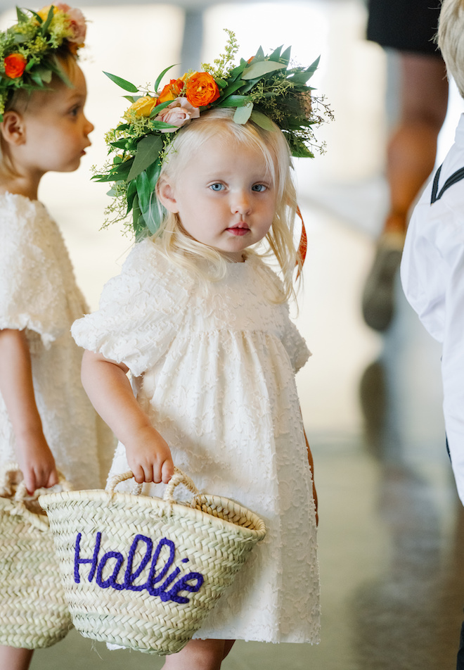 The flower girls with flower crowns and embroidered straw baskets. 