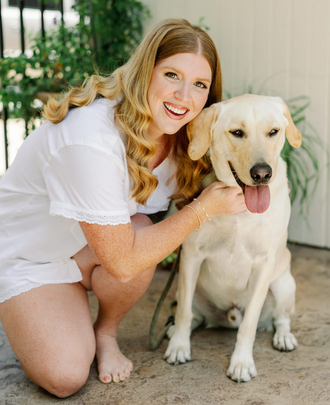 The bride posing with her white Labrador. 